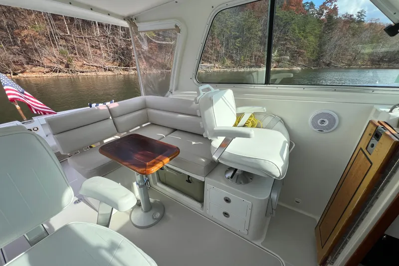 Slide: The Image of Interior of 2008 Back Cove 29 boat with seating, table, and lake view. - 18