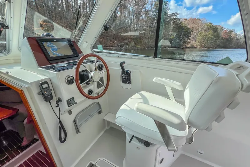 Slide: The Image of 2008 Back Cove 29 boat helm with navigation system and white captain's chair. - 19