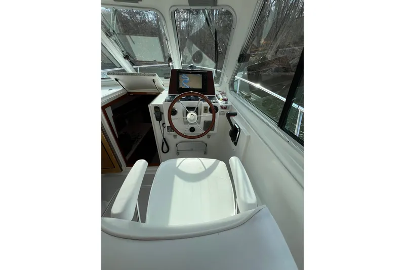 Slide: The Image of 2008 Back Cove 29 boat interior with steering wheel and navigation system. - 20