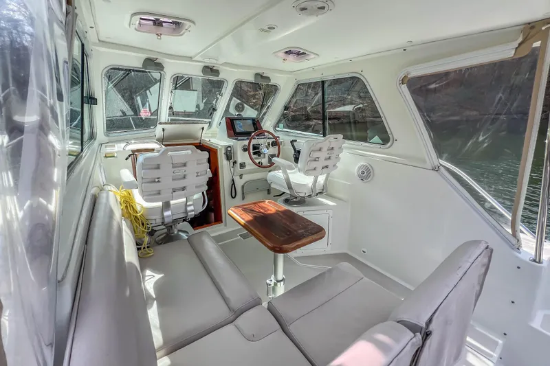 Slide: The Image of 2008 Back Cove 29 boat interior with seating, steering wheel, and navigation equipment. - 21