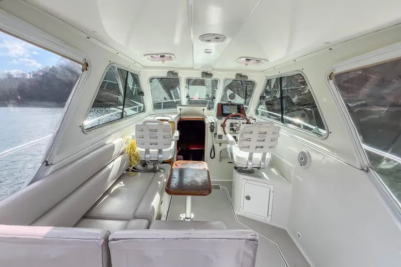 Slide: The Image of Interior of a 2008 Back Cove 29 boat with seating and helm station. - 25
