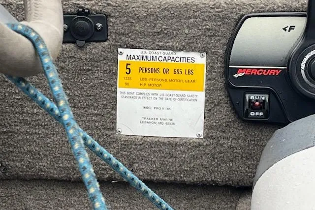 Slide: The Image of 2003 Tracker Pro Team 185 capacity label, showing maximum 5 persons or 685 lbs. - 10