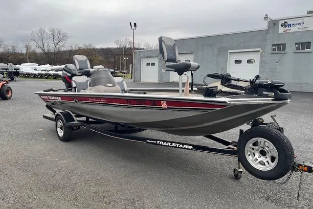 Slide: The Image of 2003 Tracker Pro Team 185 fishing boat on a trailer, parked outdoors. - 4