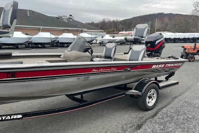 Slide: The Image of 2003 Tracker Pro Team 185 bass boat on trailer, parked outdoors. - 5