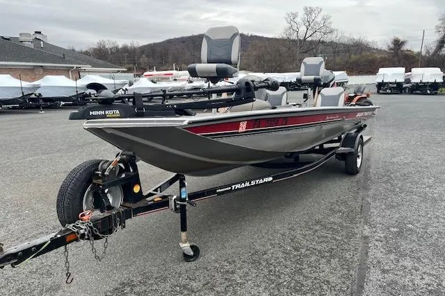 Slide: The Image of 2003 Tracker Pro Team 185 fishing boat on a trailer in a parking lot. - 6