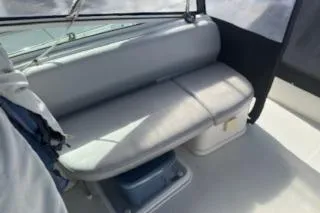 Slide: The Image of 2005 Carver 36 Mariner boat interior with cushioned seating and storage. - 11