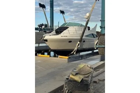 Slide: The Image of 2005 Carver 36 Mariner yacht docked at a marina under a cloudy sky. - 14