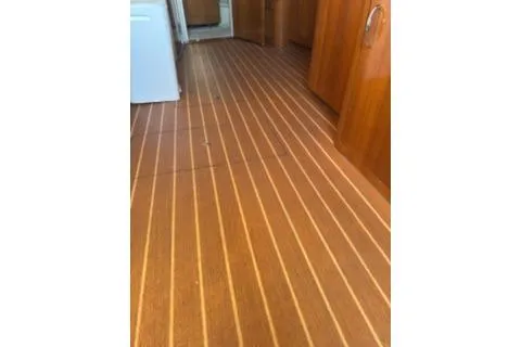 Slide: The Image of 2005 Carver 36 Mariner interior with wooden flooring and cabinetry. - 16