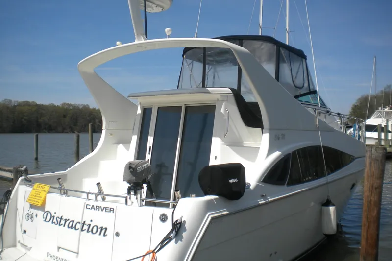 Slide: The Image of 2005 Carver 36 Mariner yacht docked at a marina, rear view. - 17