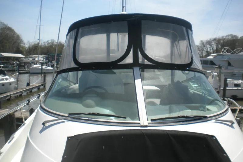 Slide: The Image of 2005 Carver 36 Mariner yacht docked at a marina, featuring a sleek windshield design. - 19