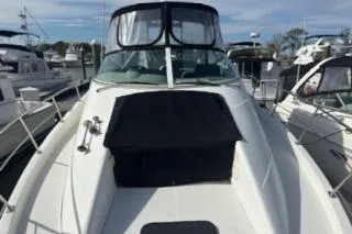 Slide: The Image of 2005 Carver 36 Mariner yacht docked at a marina, showcasing sleek design and spacious deck. - 2