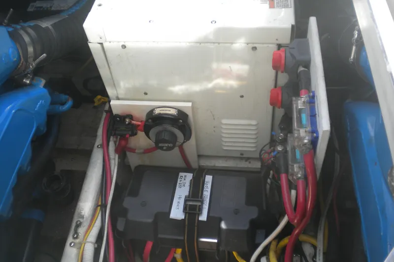 Slide: The Image of Engine compartment of 2005 Carver 36 Mariner with wiring and battery components. - 23