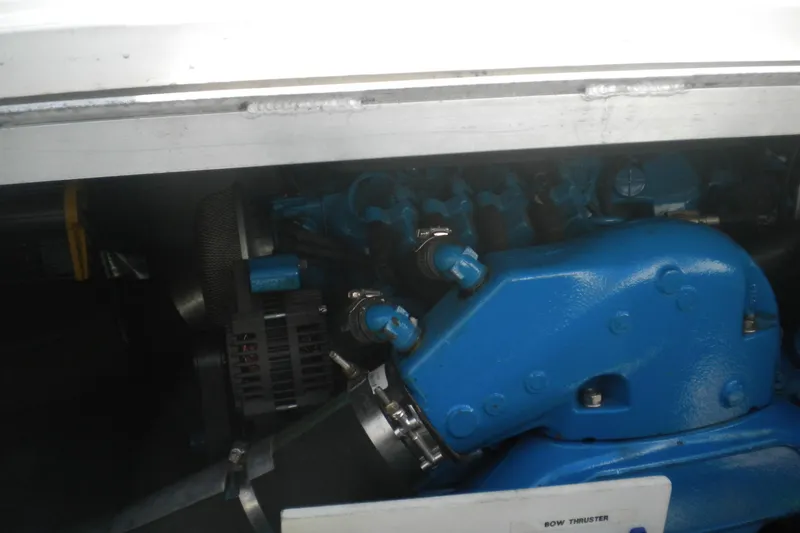 Slide: The Image of Engine compartment of a 2005 Carver 36 Mariner boat, featuring a blue engine component. - 24