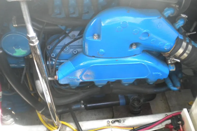 Slide: The Image of Engine compartment of a 2005 Carver 36 Mariner, featuring a blue engine component. - 25