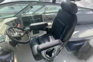 Slide: The Image of 2005 Carver 36 Mariner helm with black captain's chair and control panel. - 3