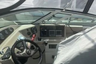 Slide: The Image of 2005 Carver 36 Mariner cockpit with steering wheel and control panel. - 5