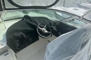 Slide: The Image of 2005 Carver 36 Mariner helm with covered controls and steering wheel. - 6