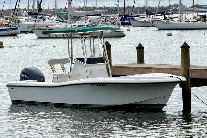 Slide: The Image of Custom 2003 23 Center Console boat docked, featuring Yamaha outboard motor. - 0