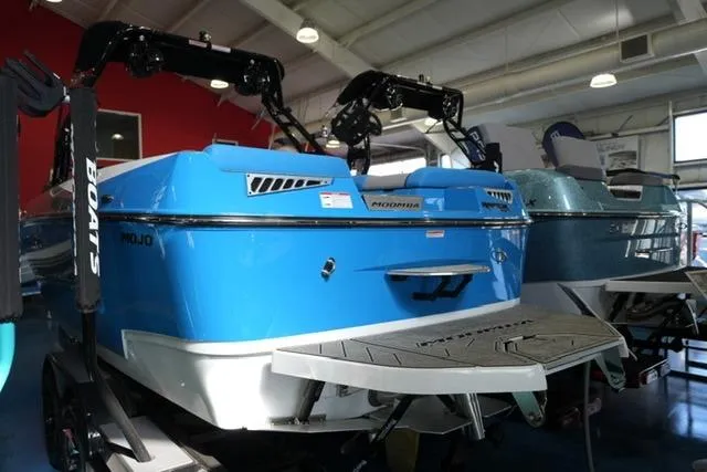 Slide: The Image of 2026 Moomba Mojo boat in showroom, vibrant blue exterior, sleek design. - 14