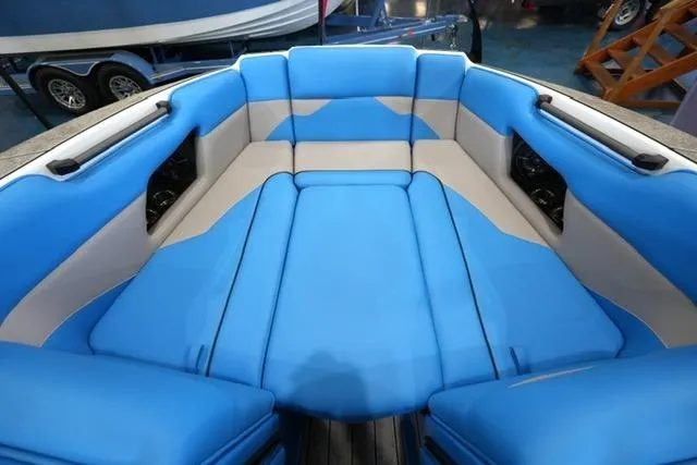 Slide: The Image of 2026 Moomba Mojo boat interior with blue and gray seating, showcasing spacious and comfortable design. - 16