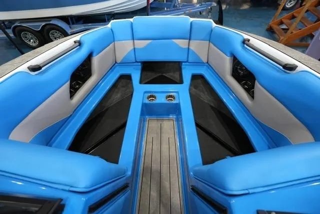 Slide: The Image of 2026 Moomba Mojo boat interior with vibrant blue seating and cup holders. - 17