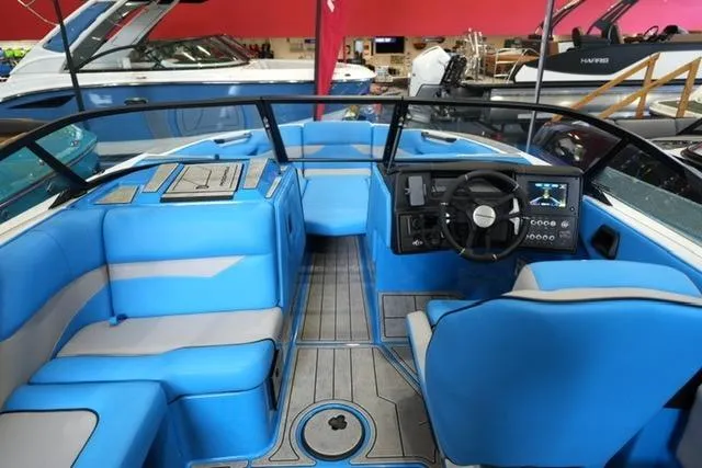 Slide: The Image of 2026 Moomba Mojo boat interior with blue seating and modern dashboard. - 19