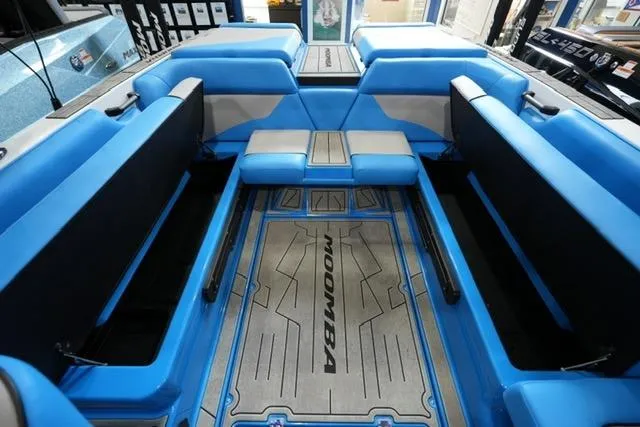 Slide: The Image of 2026 Moomba Mojo boat interior with blue seating and branded flooring. - 23