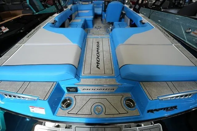 Slide: The Image of 2026 Moomba Mojo boat interior with blue and gray seating, featuring Raptor branding. - 24