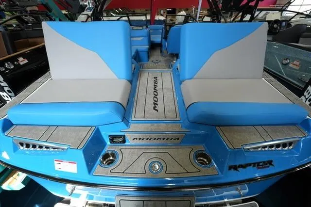 Slide: The Image of 2026 Moomba Mojo boat interior with blue and gray seating, showcasing modern design. - 25