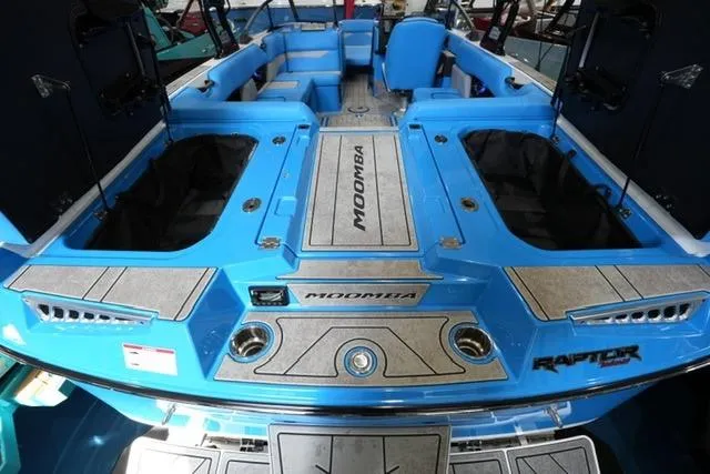 Slide: The Image of 2026 Moomba Mojo boat interior with blue seating and storage compartments. - 26