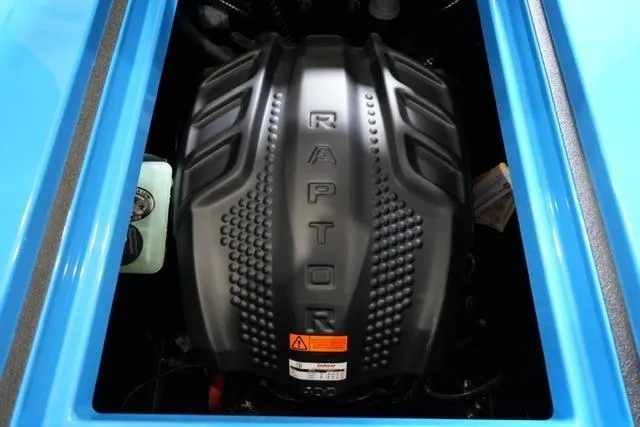 Slide: The Image of 2026 Moomba Mojo engine featuring a powerful Raptor cover, showcased in a vibrant blue compartment. - 29
