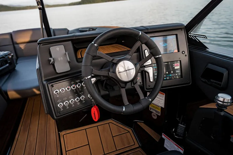 Slide: The Image of Manufacturer Provided Image: 2026 Moomba Mojo boat dashboard with steering wheel and control panel on a lake. - 4
