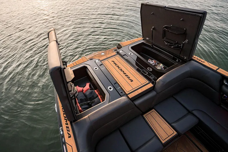 Slide: The Image of Manufacturer Provided Image: 2026 Moomba Mojo boat with open storage compartments on calm water. - 8