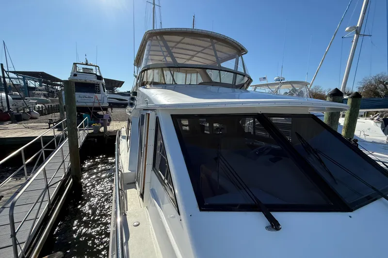 Slide: The Image of 1999 Navigator 5300 yacht docked at marina under clear blue sky. - 10
