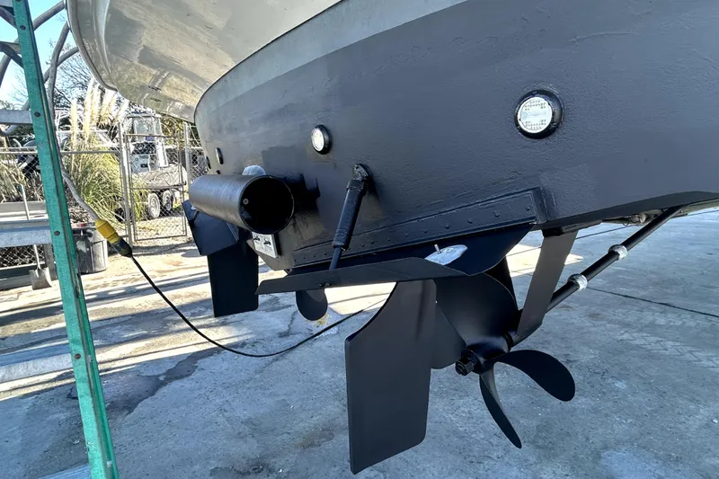 Slide: The Image of 1999 Navigator 5300 yacht stern with propeller and exhaust, docked on concrete. - 103