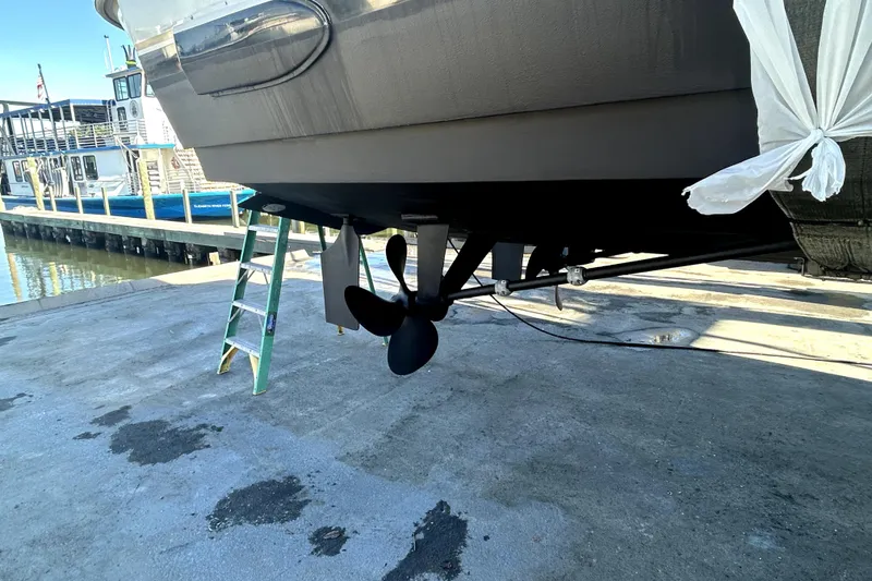 Slide: The Image of 1999 Navigator 5300 yacht on dry dock, showing propeller and ladder nearby. - 104