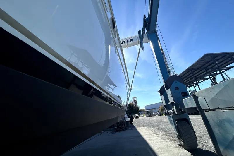 Slide: The Image of 1999 Navigator 5300 yacht in dry dock, side view with blue sky background. - 105