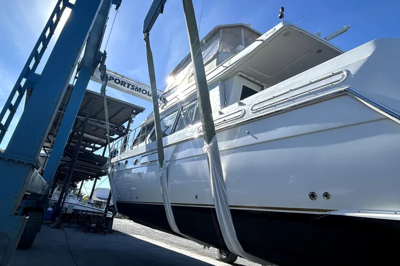 Slide: The Image of 1999 Navigator 5300 yacht being lifted at Portsmouth marina under clear blue sky. - 107