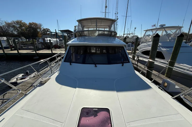 Slide: The Image of 1999 Navigator 5300 yacht docked at marina, sunny day, clear sky, luxury boat. - 11