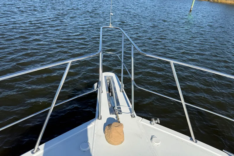 Slide: The Image of Bow view of 1999 Navigator 5300 yacht on calm water. - 13