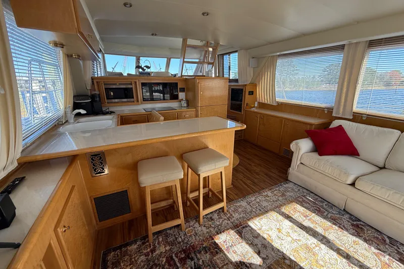 Slide: The Image of Luxurious 1999 Navigator 5300 yacht interior with modern kitchen and cozy seating area. - 15
