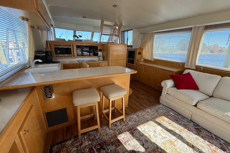 Slide: The Image of Luxurious interior of a 1999 Navigator 5300 yacht with kitchen and seating area. - 17
