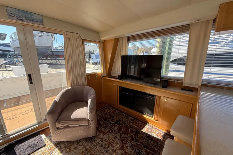 Slide: The Image of Interior of 1999 Navigator 5300 yacht with cozy seating and TV setup. - 18