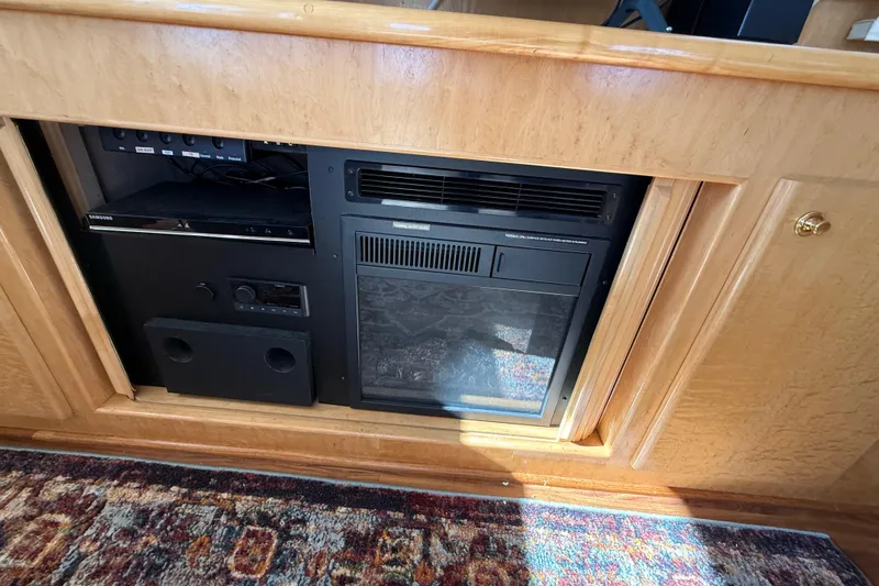 Slide: The Image of Entertainment system in 1999 Navigator 5300 yacht with wood paneling and carpet. - 19