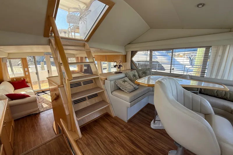 Slide: The Image of Luxurious interior of 1999 Navigator 5300 yacht with seating and dining area. - 22
