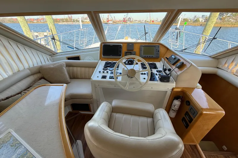 Slide: The Image of Luxurious 1999 Navigator 5300 yacht helm with leather seating and advanced navigation controls. - 25