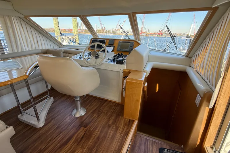 Slide: The Image of Interior of 1999 Navigator 5300 yacht with helm, wooden flooring, and water view. - 35