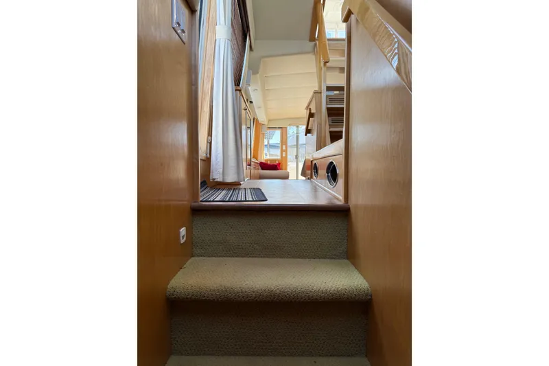 Slide: The Image of Interior view of 1999 Navigator 5300 yacht, featuring carpeted stairs and wooden paneling. - 37