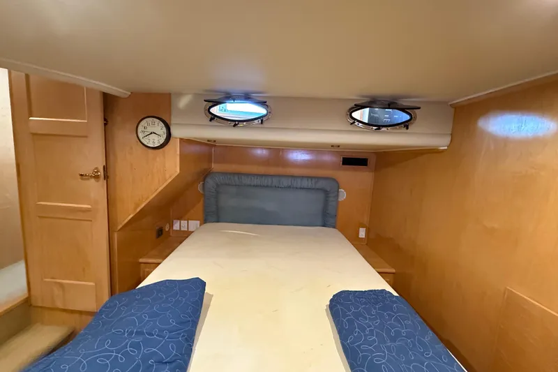 Slide: The Image of Cozy cabin interior of 1999 Navigator 5300 yacht with bed and portholes. - 39
