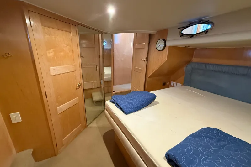 Slide: The Image of Luxurious 1999 Navigator 5300 yacht cabin with wooden interior and cozy bedding. - 41